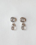 pair of silver earrings with spiral design and crystal quartz drops