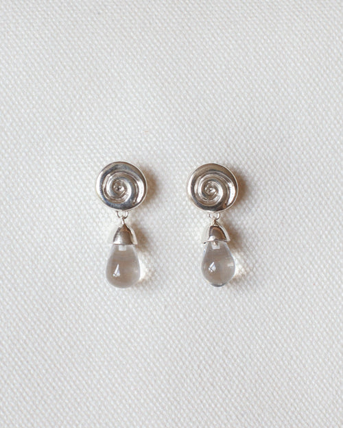 pair of silver earrings with spiral design and crystal quartz drops